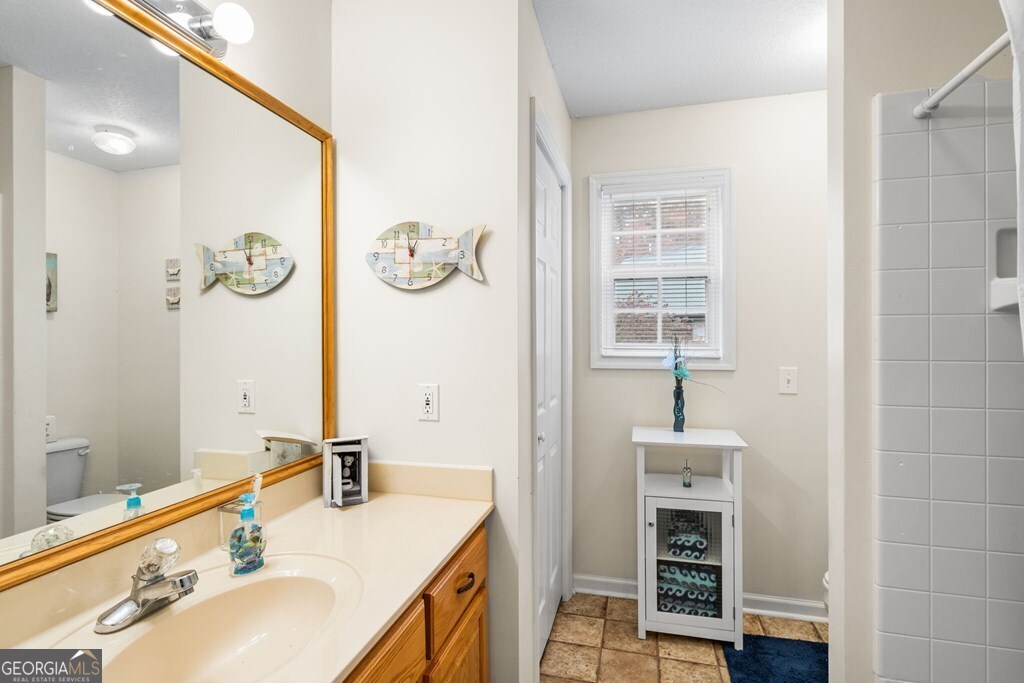 251 Rivers Edge Drive Hayesville, NC 28904 - Photo 25 of 45 a bathroom with a sink and a mirror