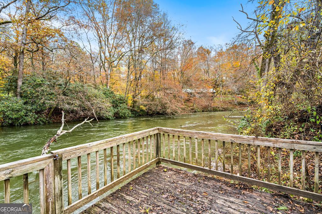 251 Rivers Edge Drive Hayesville, NC 28904 - Photo 3 of 45 a view of a wooden deck with trees in the background