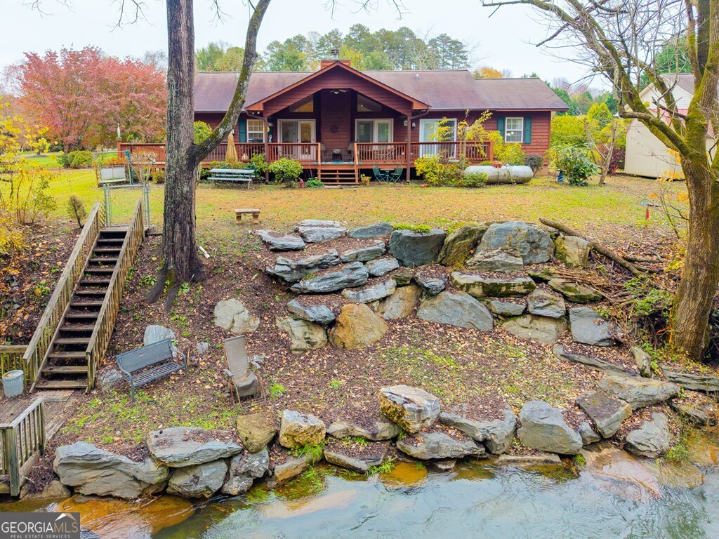 251 Rivers Edge Drive Hayesville, NC 28904 - Photo 32 of 45 a front view of a house with swimming pool yard and outdoor seating
