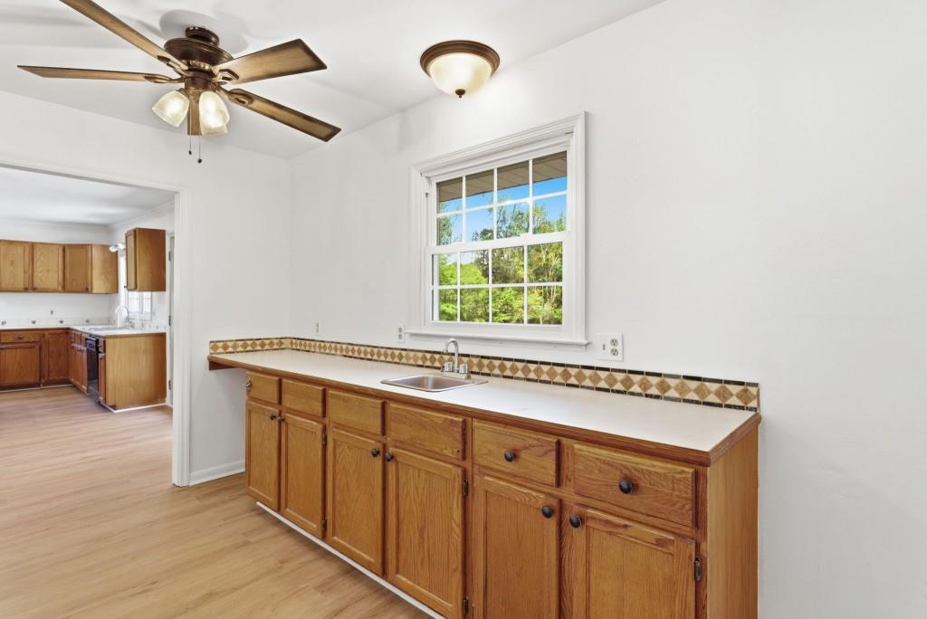224 Old Franklin Street Roopville, GA 30170 - Photo 13 of 60 a view of a kitchen with furniture and a ceiling fan