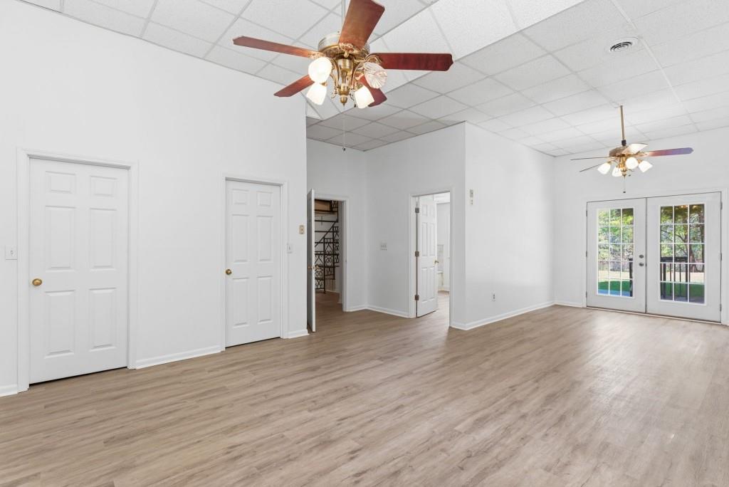224 Old Franklin Street Roopville, GA 30170 - Photo 19 of 60 an empty room with wooden floor chandelier fan and windows
