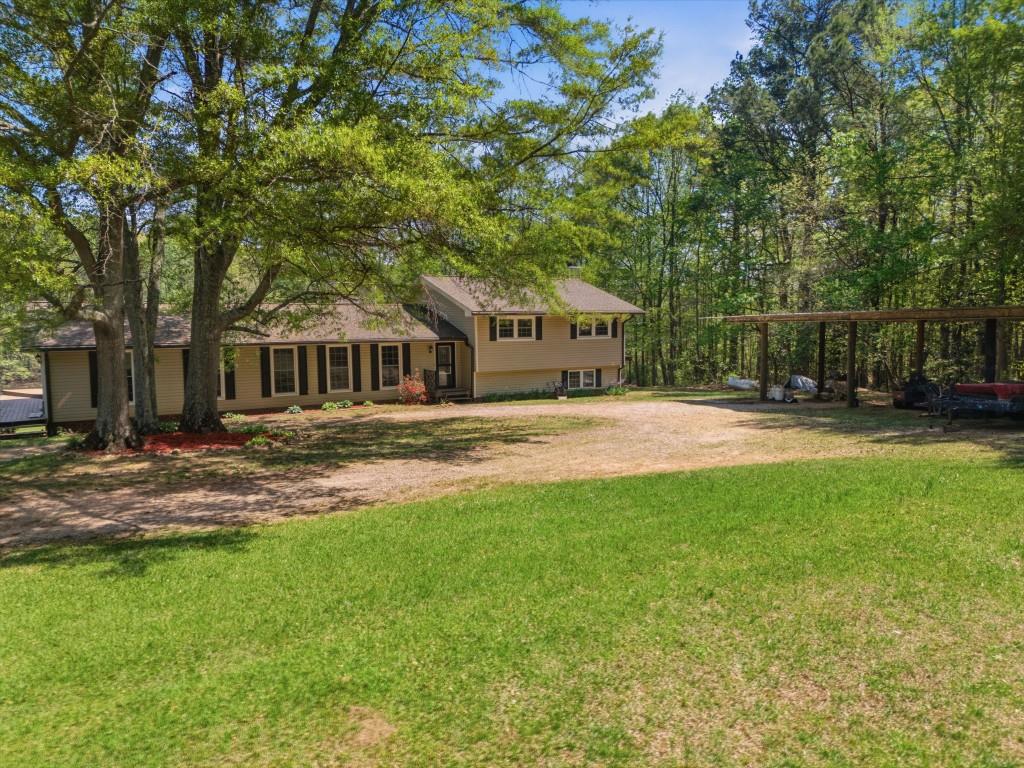 224 Old Franklin Street Roopville, GA 30170 - Photo 2 of 60 a front view of a house with garden
