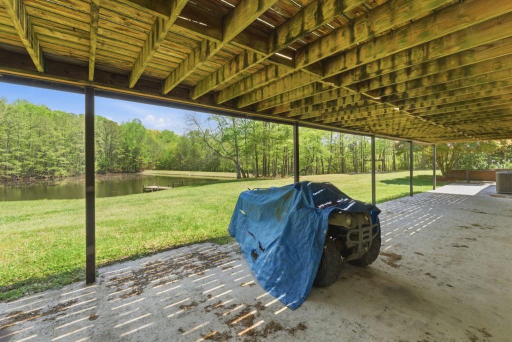224 Old Franklin Street Roopville, GA 30170 - Photo 28 of 60 a view of a backyard with table and chairs under an umbrella