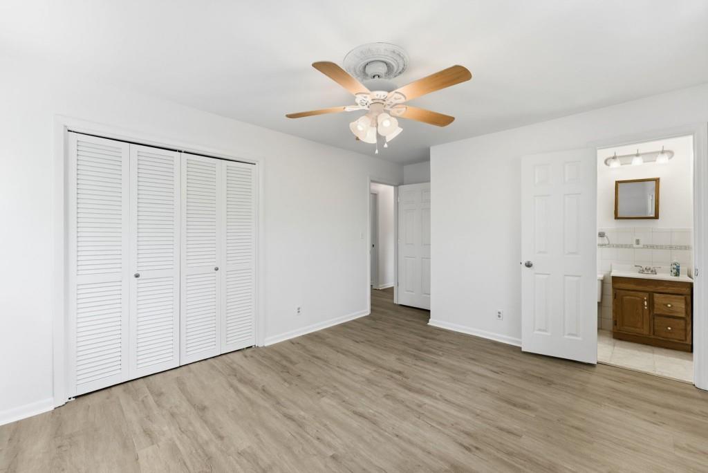 224 Old Franklin Street Roopville, GA 30170 - Photo 32 of 60 a view of an empty room with wooden floor and a ceiling fan