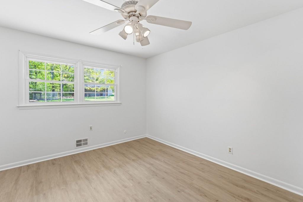224 Old Franklin Street Roopville, GA 30170 - Photo 34 of 60 an empty room with wooden floor and windows