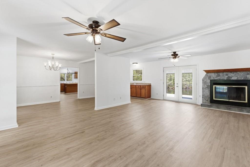 224 Old Franklin Street Roopville, GA 30170 - Photo 5 of 60 a view of empty room with wooden floor and fireplace
