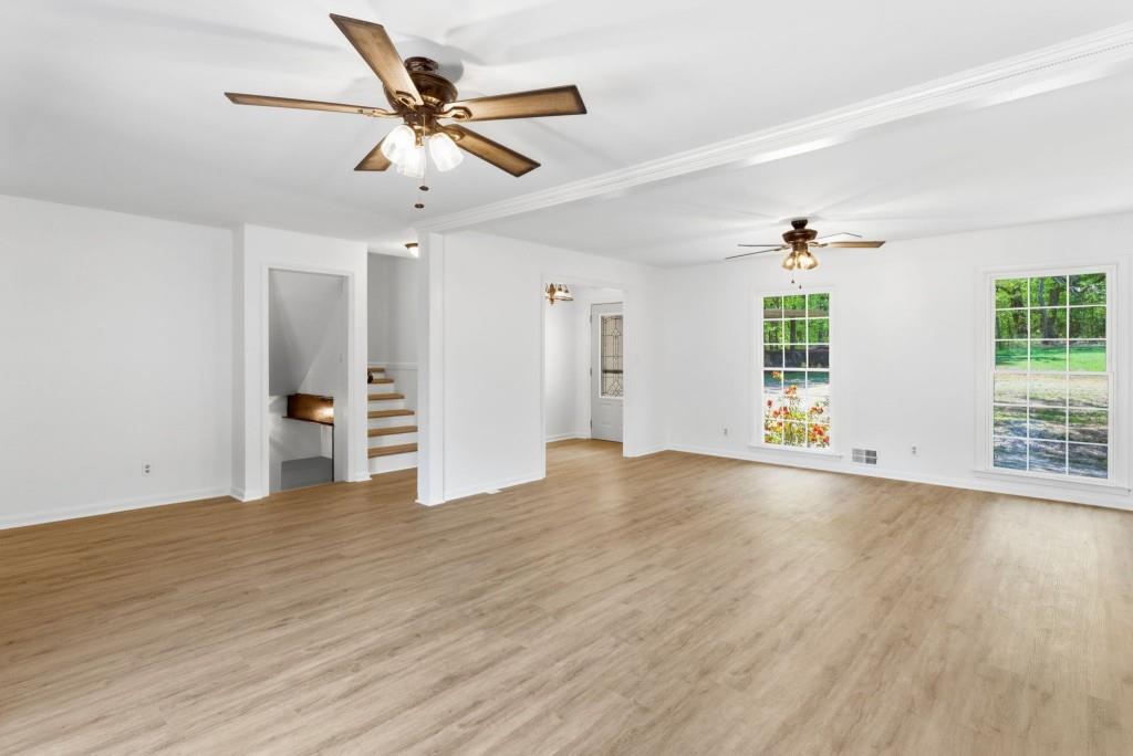 224 Old Franklin Street Roopville, GA 30170 - Photo 7 of 60 a view of an empty room with a window and wooden floor
