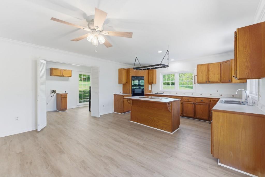 224 Old Franklin Street Roopville, GA 30170 - Photo 10 of 60 a kitchen with stainless steel appliances kitchen island wooden cabinets and granite counter tops