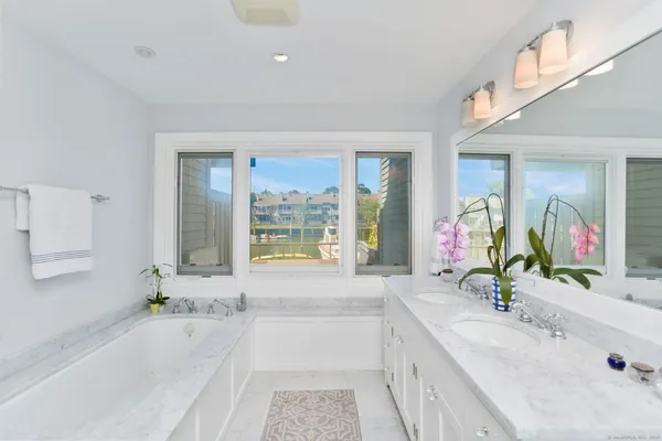 a bathroom with sink bathtub and window