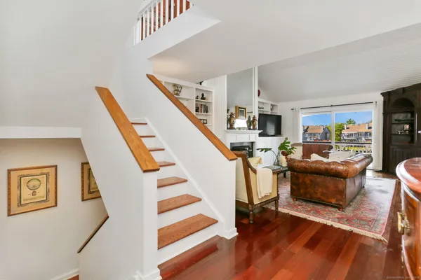 a view of entryway and hall with wooden floor