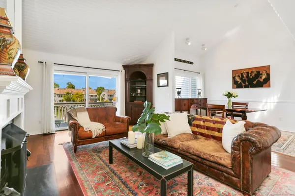 a living room with furniture a rug and a flat screen tv