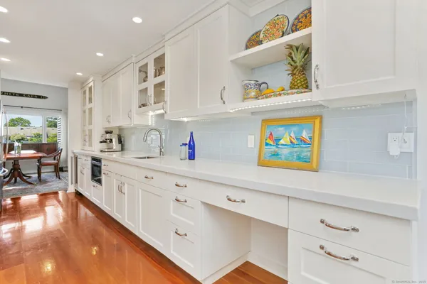 a kitchen with stainless steel appliances cabinets and a window
