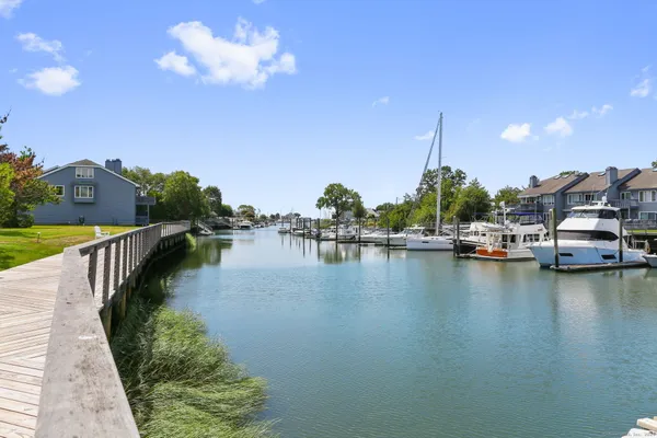 a view of a lake with boats and trees in the background