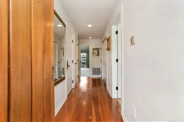 a view of a hallway with wooden floor