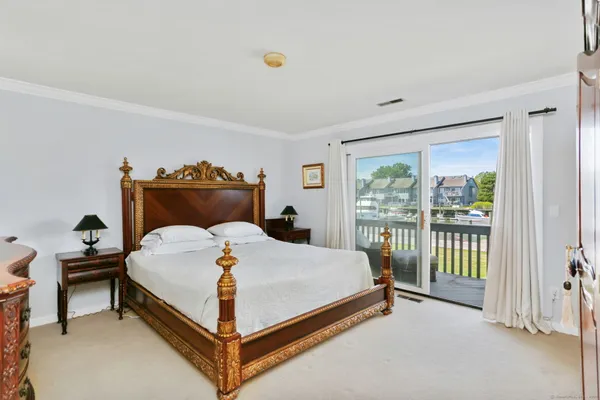 a bedroom with a bed and large window