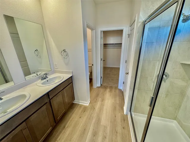 a bathroom with a sink a mirror and a shower