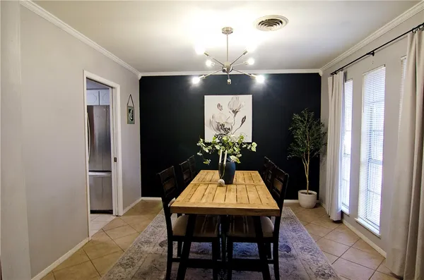 a view of a dining room with a table and chairs