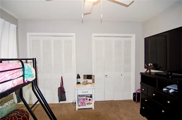 a bedroom with furniture and a book shelf