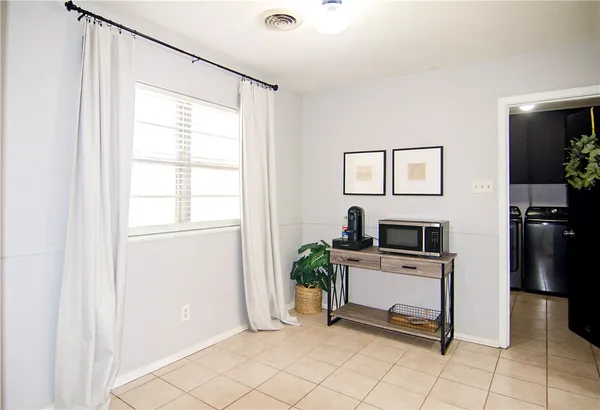a utility room with cabinets washer and dryer