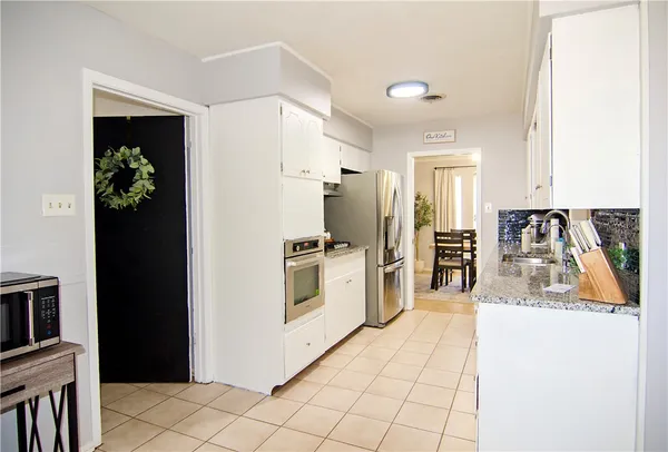 a kitchen with stainless steel appliances a refrigerator and a stove