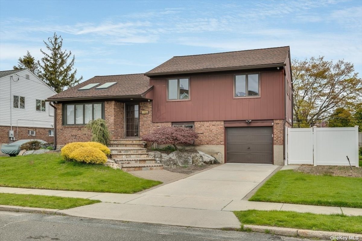 28 Clark Street Plainview, NY 11803 - Photo 1 of 1 a front view of a house with garden