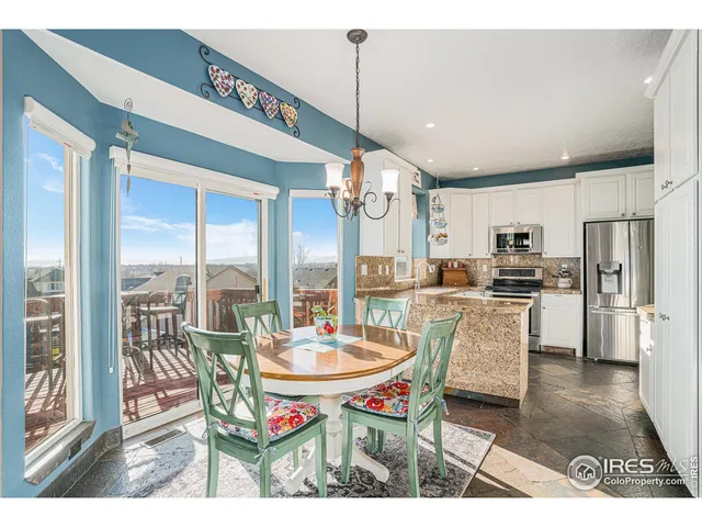 a dining room with furniture a chandelier and wooden floor