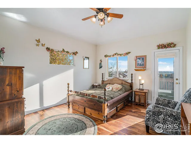 a bedroom with furniture and wooden floor