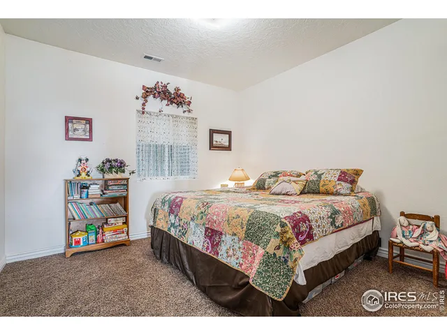 a bedroom with a bed and a book shelf