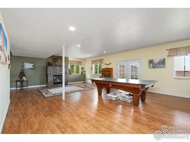 a living room with furniture a dining table and wooden floor