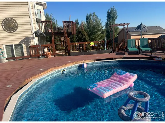 a swimming pool with outdoor seating and yard