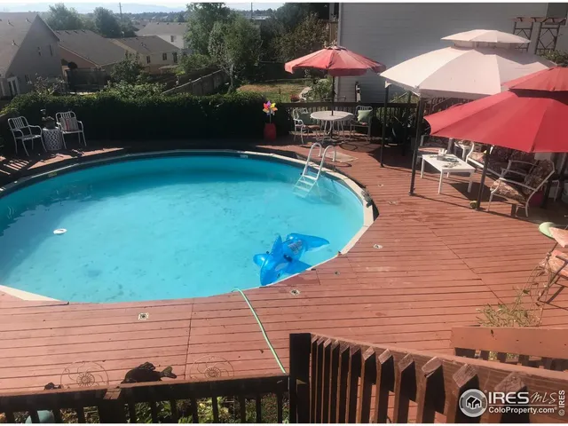 an outdoor space with pool and furniture