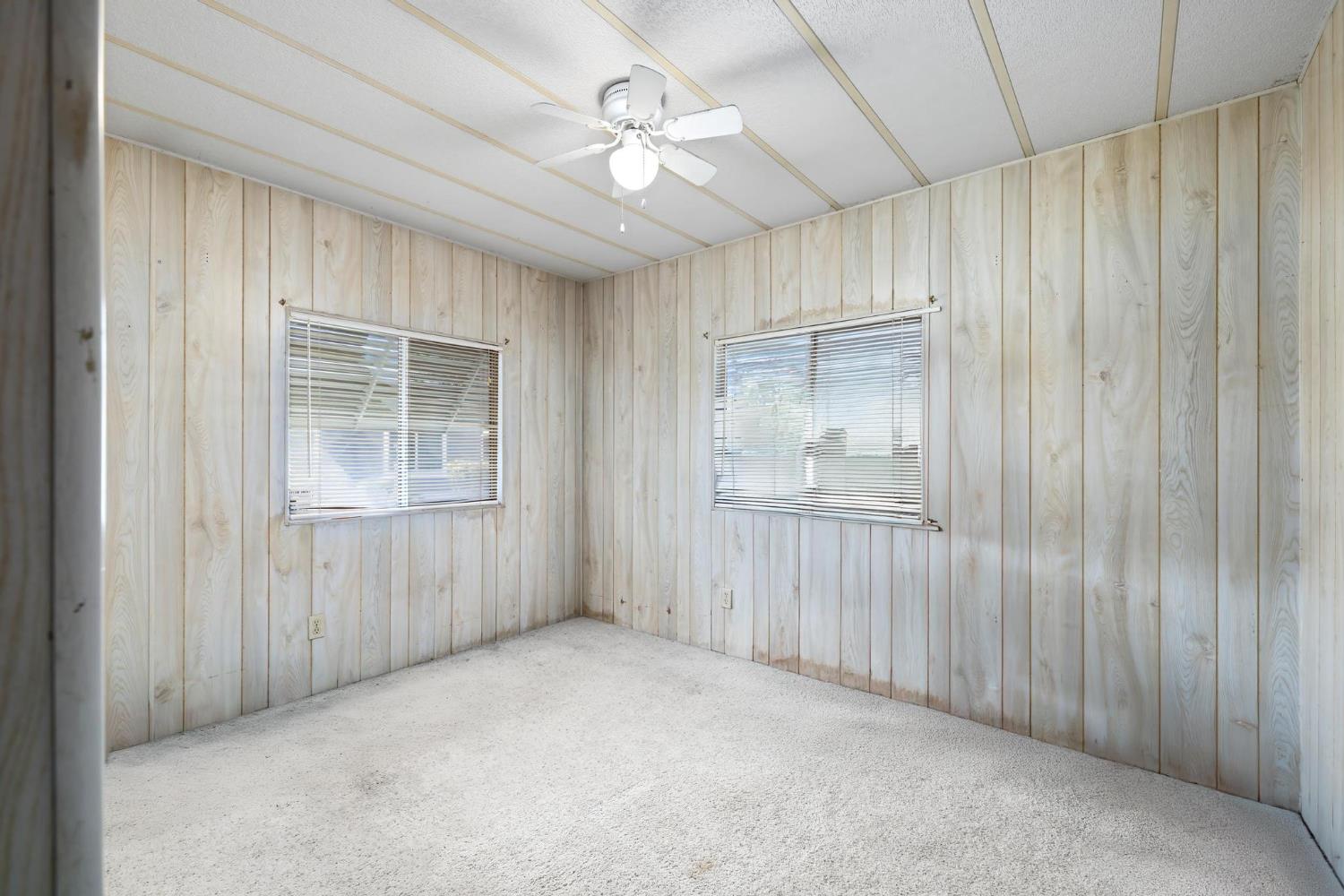 1200 South Carpenter Road, Unit 4 Modesto, CA 95351 - Photo 23 of 31 Room featuring wood-finish paneling walls and a textured ceiling