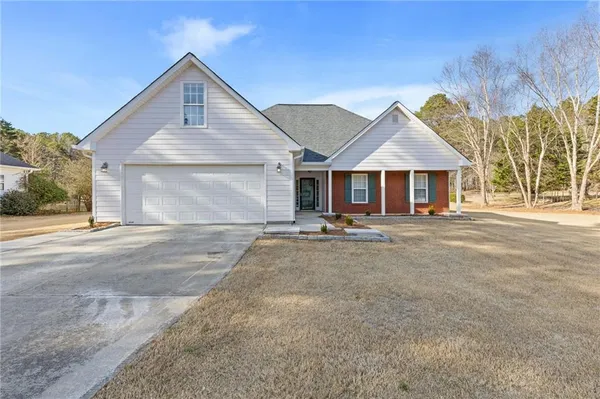 a view of a house with a yard and garage