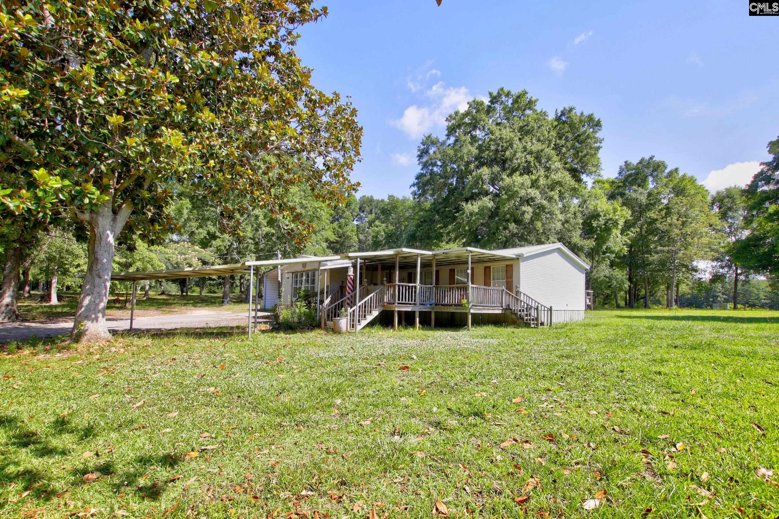 3140 Highway 702 Chappells, SC 29037 - Photo 22 of 39 a view of a house with backyard and trees