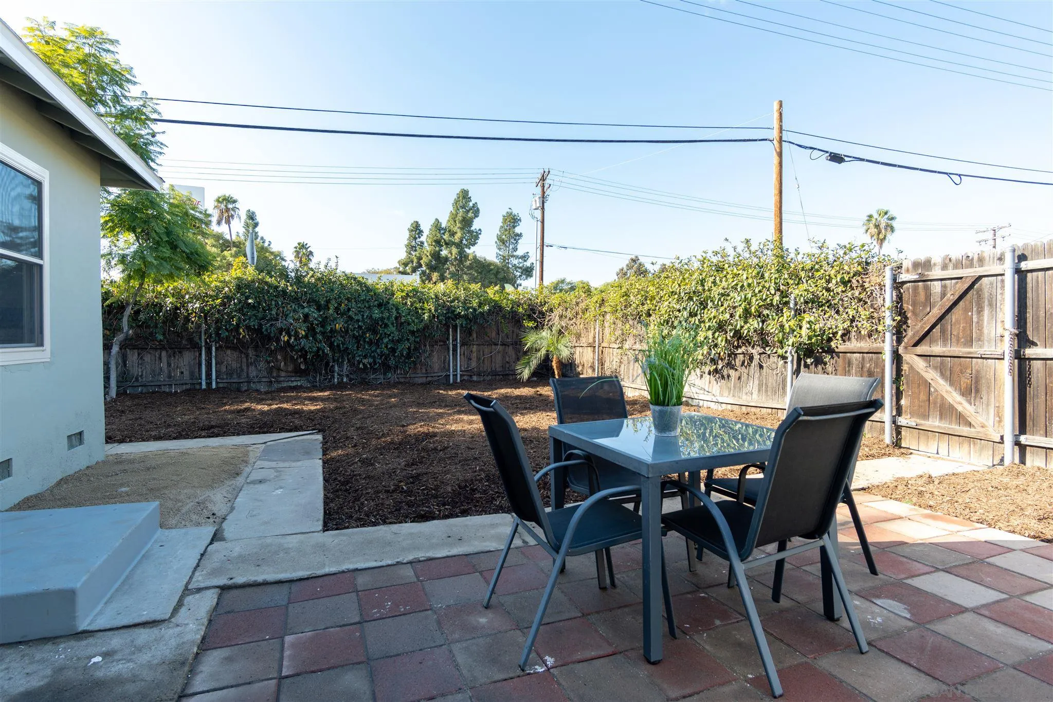 7204 Waite Drive La Mesa, CA 91941 - Photo 18 of 18 a view of a patio with table and chairs and potted plants