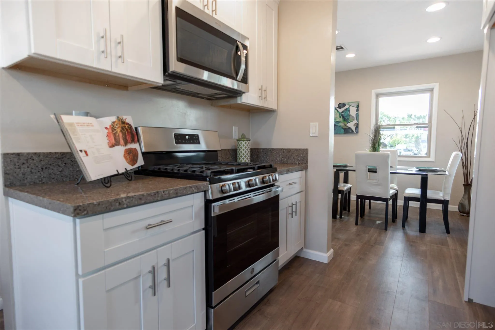 7204 Waite Drive La Mesa, CA 91941 - Photo 6 of 18 a kitchen with stainless steel appliances granite countertop a stove a sink and a microwave