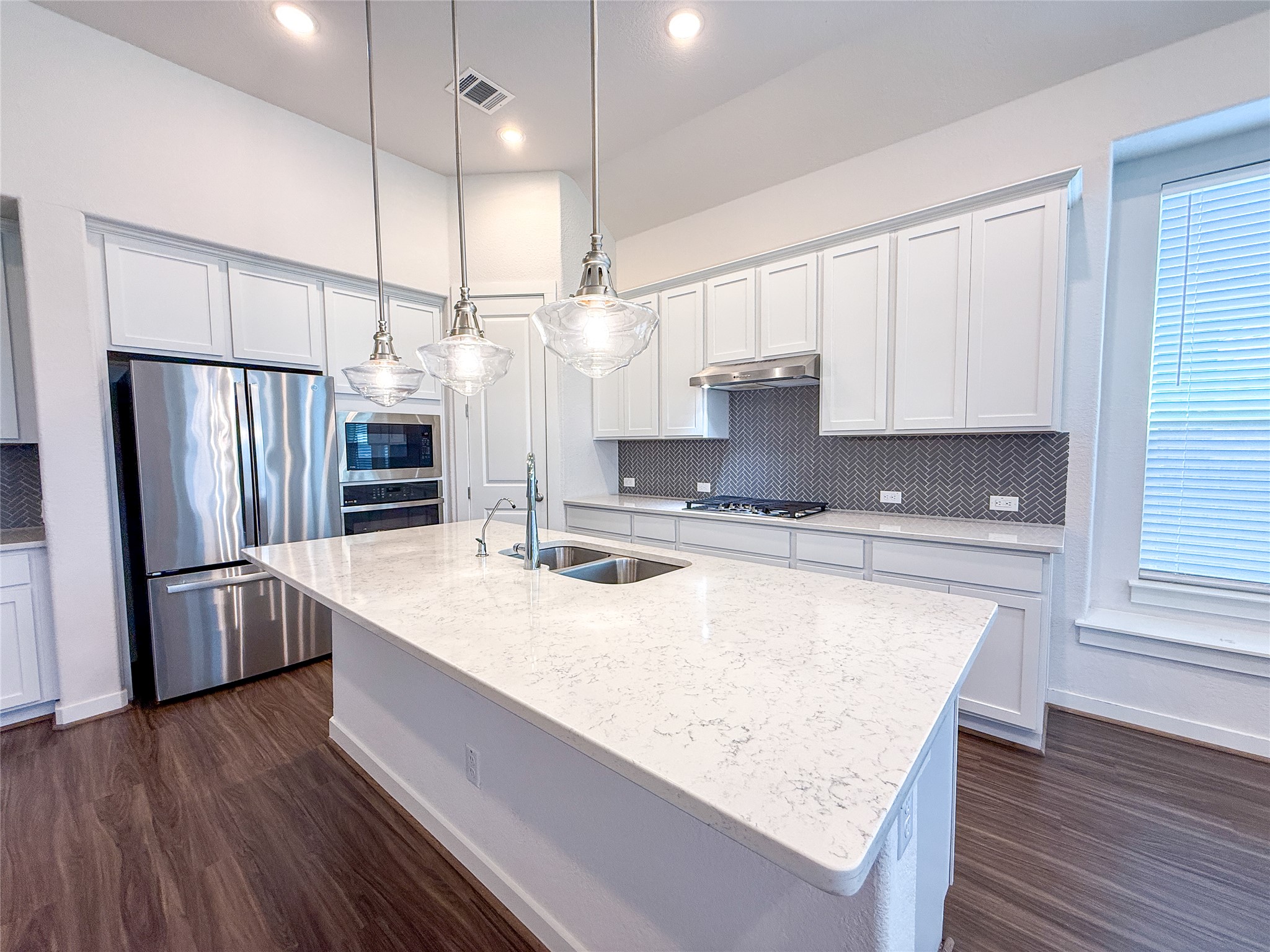 249 Heartleaf Road San Marcos, TX 78666 - Photo 12 of 38 Prepare culinary delights in this open-concept kitchen, featuring generous counter space and contemporary fixtures.