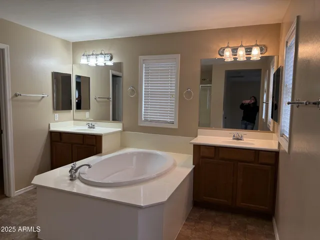 a bathroom with a sink double vanity and a mirror