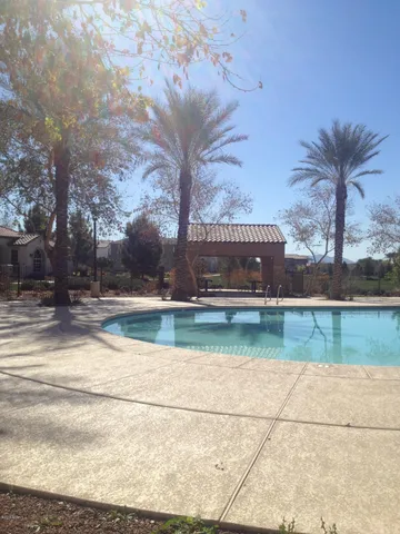 a view of a swimming pool with a yard