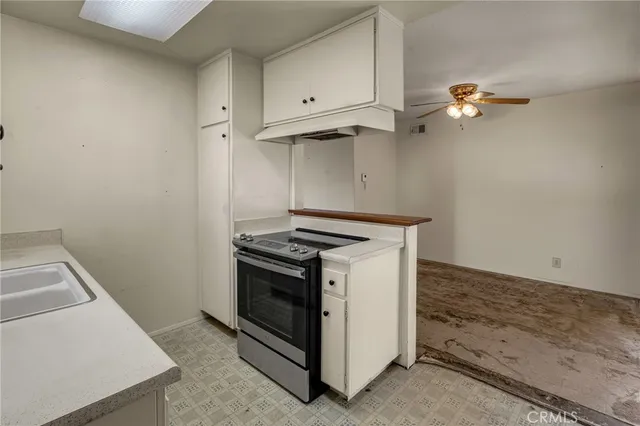 a stove top oven sitting inside of a kitchen