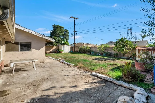 a view of a patio with table and chairs potted plants