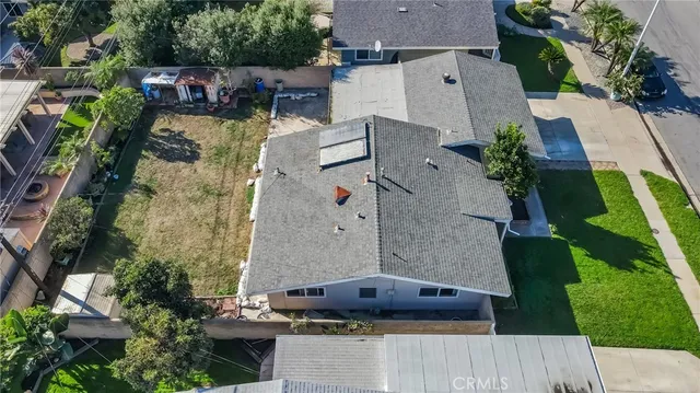 an aerial view of a house with a yard