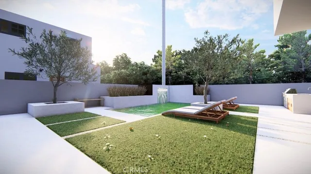 a view of a backyard with lawn chairs potted plants and tree