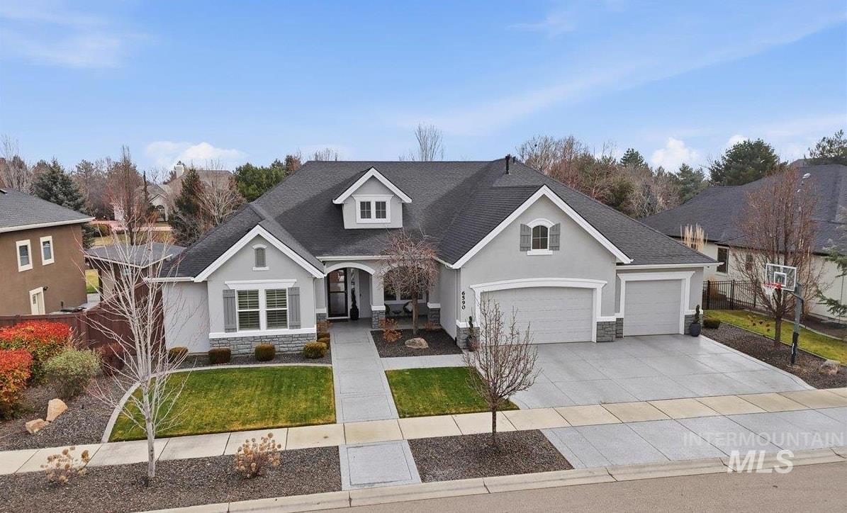 6590 North Fairborn Avenue Meridian, ID 83646 - Photo 1 of 49 View of front of property featuring stone siding, stucco siding, and roof with shingles
