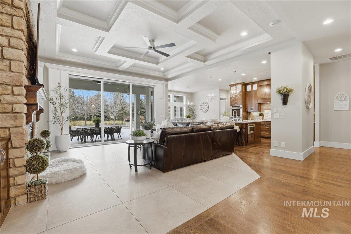 6590 North Fairborn Avenue Meridian, ID 83646 - Photo 13 of 49 Living area with a ceiling fan, coffered ceiling, a chandelier, recessed lighting, and beamed ceiling