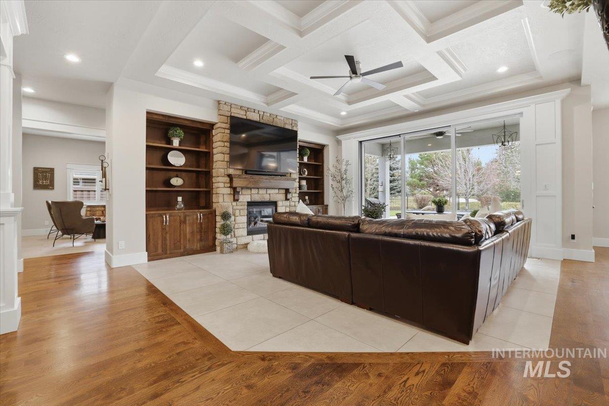 6590 North Fairborn Avenue Meridian, ID 83646 - Photo 18 of 49 Living area featuring ceiling fan, light wood-style floors, recessed lighting, coffered ceiling, and a fireplace