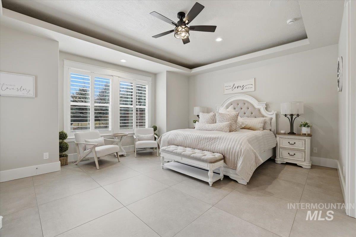 6590 North Fairborn Avenue Meridian, ID 83646 - Photo 26 of 49 Bedroom with a ceiling fan, a tray ceiling, light tile patterned flooring, and recessed lighting