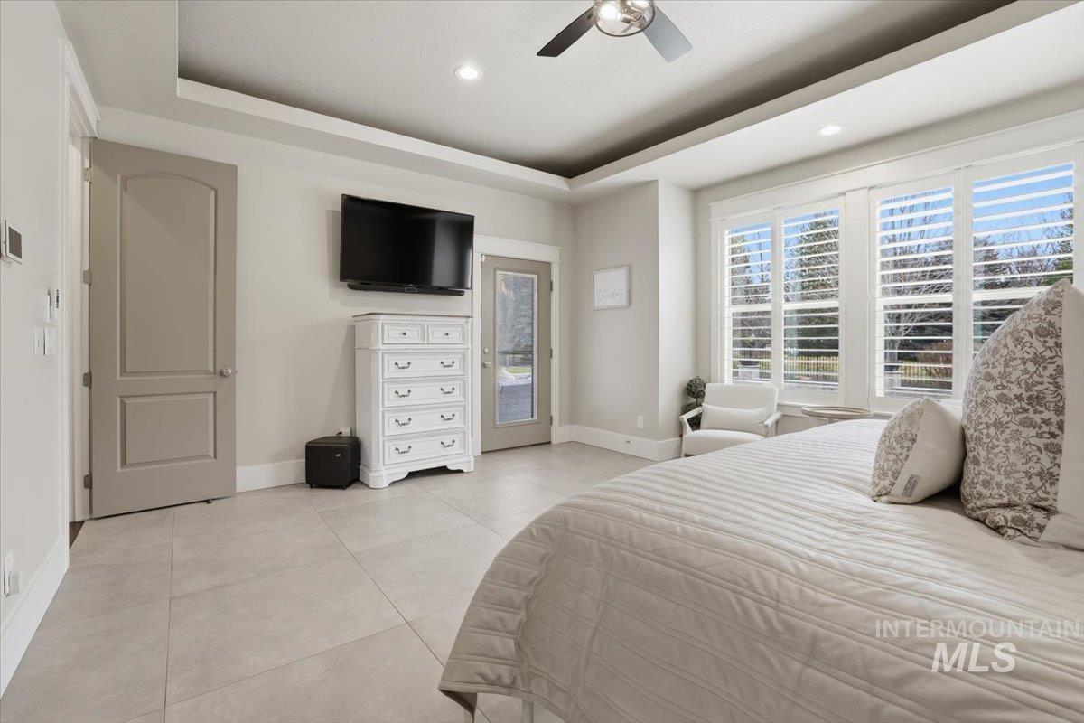 6590 North Fairborn Avenue Meridian, ID 83646 - Photo 27 of 49 Bedroom featuring a raised ceiling, access to exterior, ceiling fan, and recessed lighting