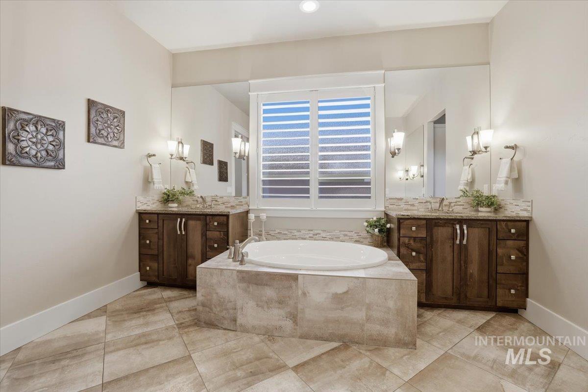 6590 North Fairborn Avenue Meridian, ID 83646 - Photo 30 of 49 Full bath featuring two vanities and a garden tub