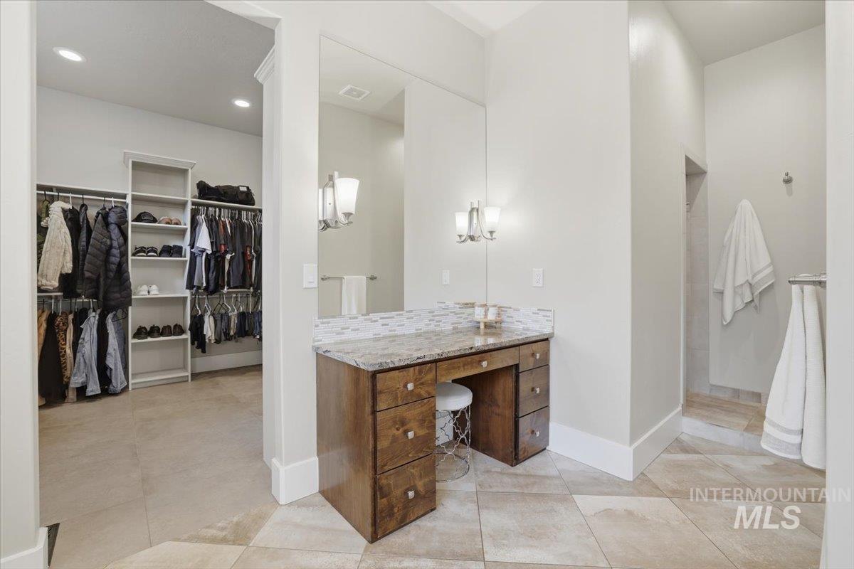 6590 North Fairborn Avenue Meridian, ID 83646 - Photo 32 of 49 Full bathroom featuring a walk in closet, vanity, and light tile patterned floors